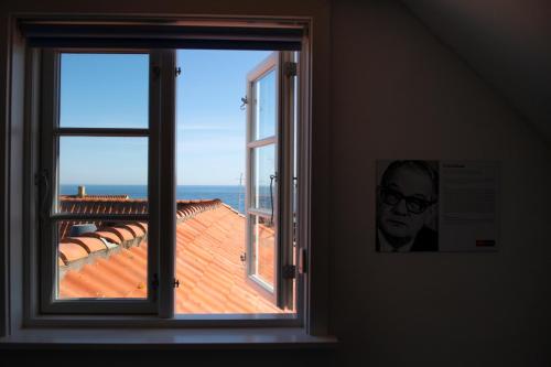 a window in a room with a view of the ocean at Grønbechs Hotel in Allinge