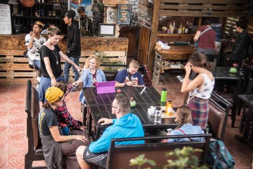 a group of people sitting around a table in a restaurant at Wander Thirst in Kathmandu