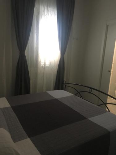 a bedroom with a bed with a window at Aeroporto Bellini Rooms in Catania