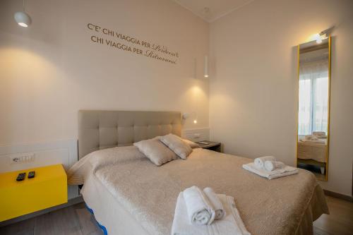 a bedroom with a bed with towels on it at Residenza Eleonora in Salerno
