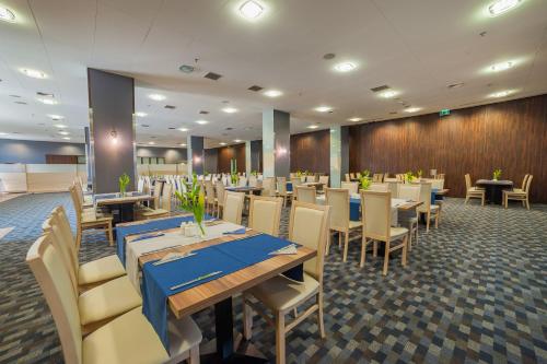 a restaurant with tables and chairs in a room at Premier Kraków Hotel in Kraków
