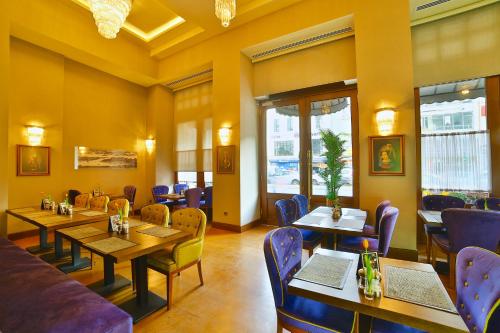 a restaurant with tables and chairs and a couch at Hotel Momento Golden Horn in Istanbul