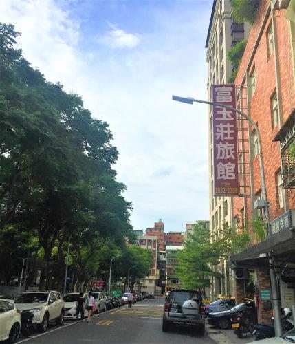 a city street with cars parked on the side of a building at Rich Zone Hotel in Taipei