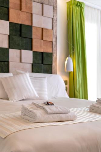 a hotel room with two beds with towels on the bed at Ca' de la Fonte - WENICE Deep Culture in Venice