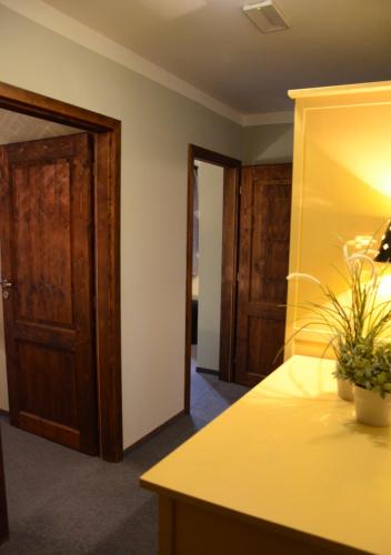a room with a yellow counter and wooden doors at Kazmarka in Malá Morávka