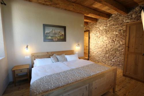 A bed or beds in a room at Agritur Ciastel