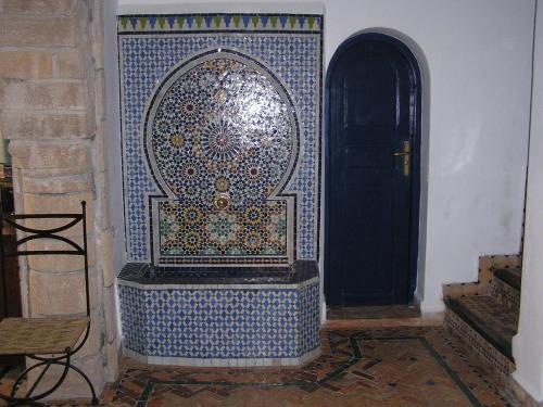 a room with a door with a mosaic patterned wall at Dar Al Bahar in Essaouira
