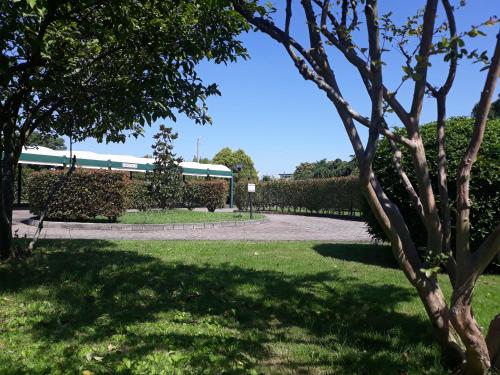 a park with trees and a building in the background at Hotel Motel Luna in Segrate