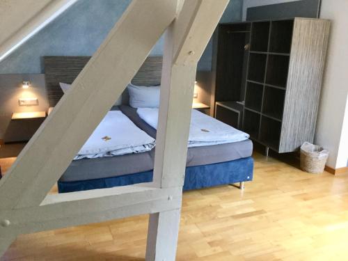 a bedroom with a bunk bed and a staircase at Badischer Hof in Bühl