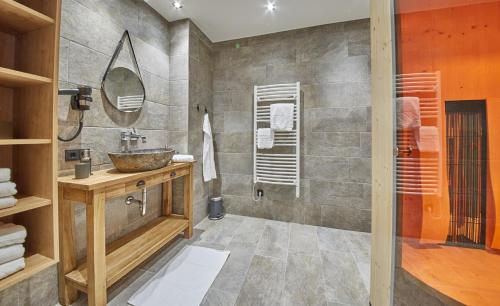 a bathroom with a sink and a mirror at Appartements Der Fuchsbau in Saalbach Hinterglemm