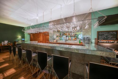 a bar in a restaurant with a bunch of chairs at The Blue Water - Geoffrey Bawa Heritage Resort Hotel in Wadduwa
