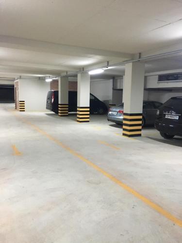 an empty parking garage with cars parked in it at Domus Hotel & Apartments in Shëngjin