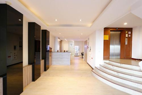 a hallway of a building with stairs and a bar at 東圓旅館 in Taichung