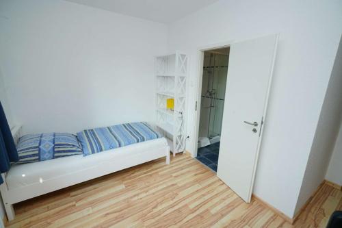 a small bedroom with a bed and a mirror at Lindenzimmer Stöcken in Oetzen