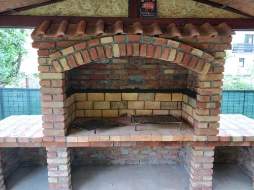 an outdoor brick oven with a grill on it at Savski Gaj in Zagreb