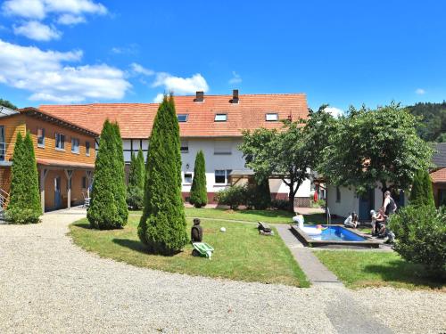 a group of people in a yard with a pool at Apartment with private terrace in H ddinge in Bad Wildungen