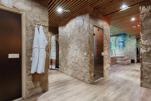 a room with a stone wall and a door at Boutique Hotel California in Odesa