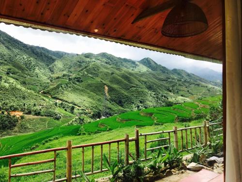 a view of the mountains from a house balcony at D&D Eco Sapa in Sa Pa