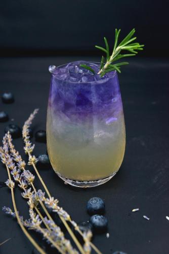 a purple drink in a glass with a plant in it at LN Hotel Five in Guangzhou