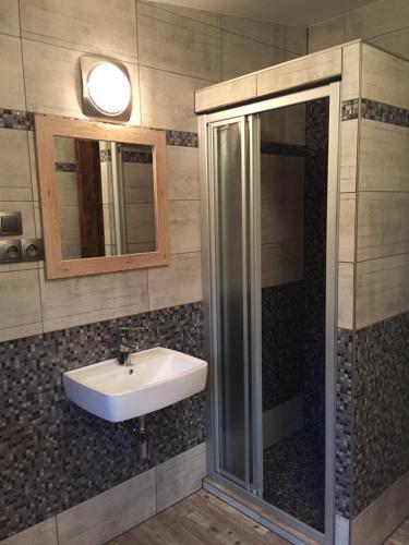 a bathroom with a sink and a shower at Kazmarka in Malá Morávka