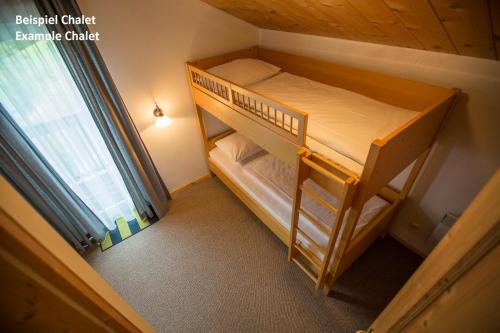 a small bedroom with a bunk bed in a room at Alpendorf Dachstein West by ALPS RESORTS in Annaberg im Lammertal
