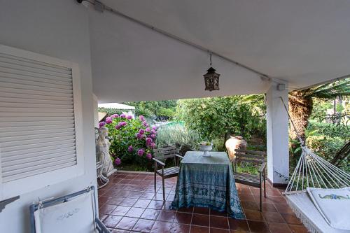 a patio with a table and chairs and flowers at Villa Hermes in San Ferdinando