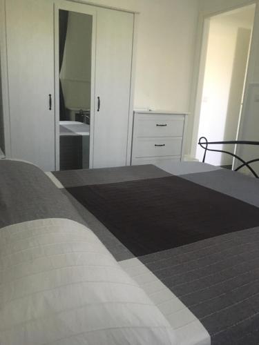 a bedroom with a bed and a bathroom with a sink at Aeroporto Bellini Rooms in Catania