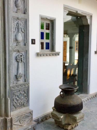 a vase sitting on the side of a building at The Neem Tree in Udaipur