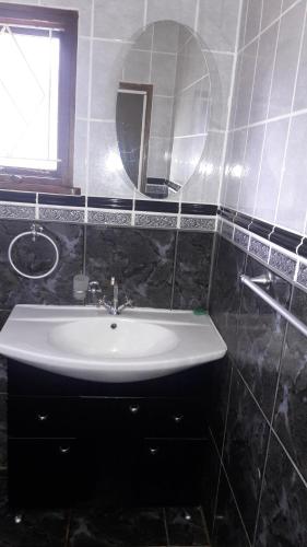 a bathroom with a sink and a mirror at Tehilah in Sabie
