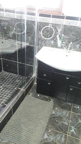 a bathroom with a sink and a bath tub at Tehilah in Sabie