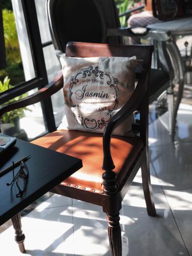 a chair with a pillow sitting on top of it at Argya Guesthouse in Yogyakarta