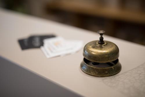 a metal object sitting on top of a white counter at Love & Fama Hotel in Sabaudia