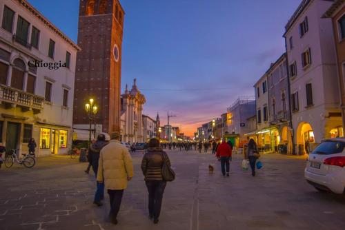 a group of people walking down a city street at Residence Delta in Rovigo
