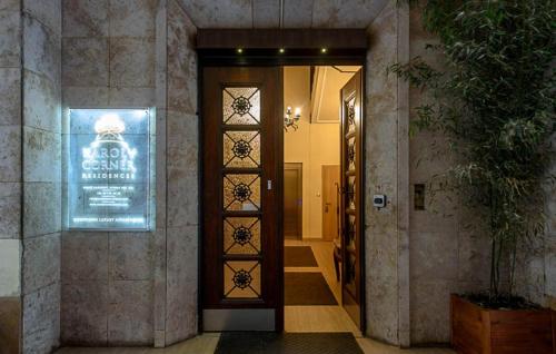 a hallway with a door with a sign on it at Karoly Corner Residences in Budapest