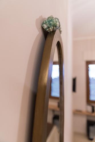 a mirror with a rope on top of it at Love & Fama Hotel in Sabaudia
