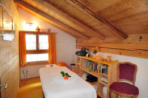 a room with a table and a book shelf at Berggasthaus Gemsli in Sankt Antönien