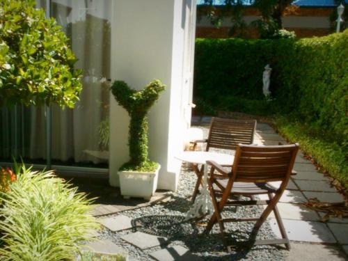 two chairs and a table on a patio at The Lighthouse Guesthouse in Colesberg