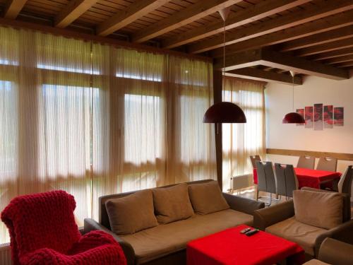 a living room with a couch and a table at Вила Комплекс Катарино in Razlog