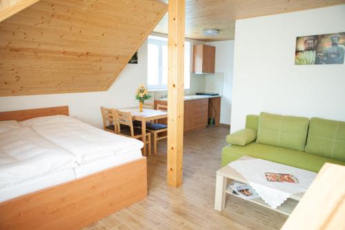 a small bedroom with a bed and a table at Vila Sofia in Luhačovice