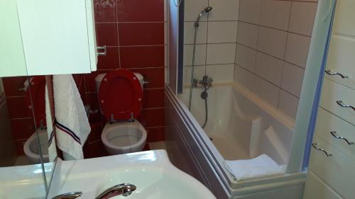 a bathroom with a toilet and a sink and a tub at Guesthouse Djacic in Budva