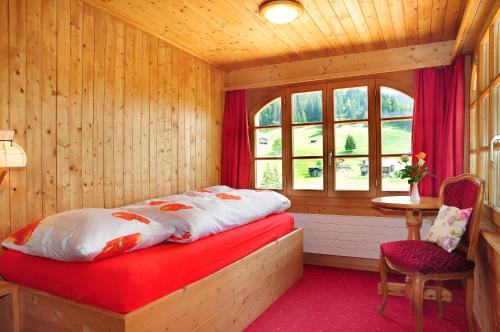 A bed or beds in a room at Berggasthaus Gemsli