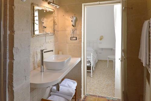 a bathroom with a sink and a mirror at B&B PALAZZO MARZO in Otranto
