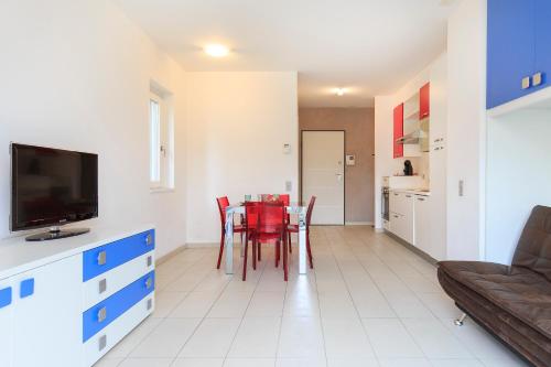 a kitchen and dining room with a table and chairs at Prestige Apartments by Quokka 360 - spacious flats with terraces in Lugano