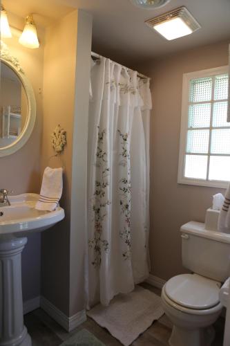 a bathroom with a toilet and a sink at Martha's Vineyard B & B in South Haven