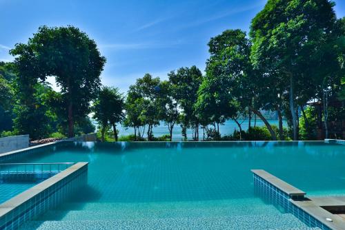 an empty swimming pool with trees in the background at Railay Great View Resort in Railay Beach