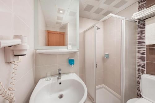 a bathroom with a shower and a sink and a toilet at Golden Orange Hotel in Antalya