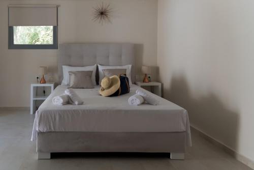 a bedroom with a bed with a hat on it at Kiperi Exclusive in Parga