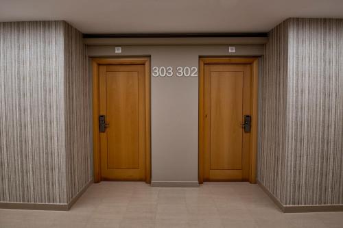 a hallway with three doors in a building at Apartamentos VIDA Mar de Laxe in Laxe