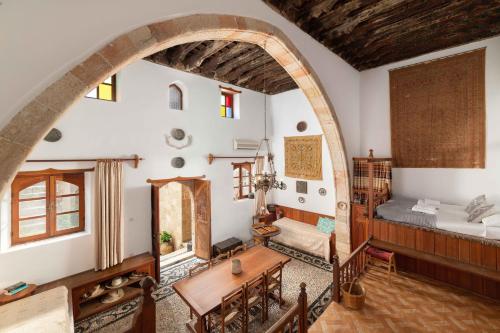 a living room with a bed and a table at Captains House in Lindos