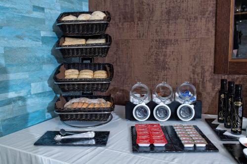 a table with baskets of bread and desserts on it at Hotel VIDA Mar de Laxe in Laxe